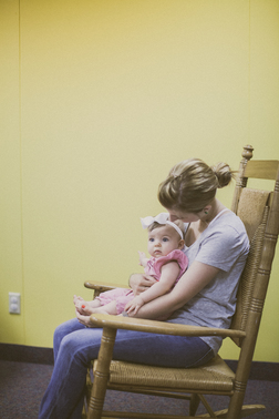 Nursery Staff Rocking A Baby